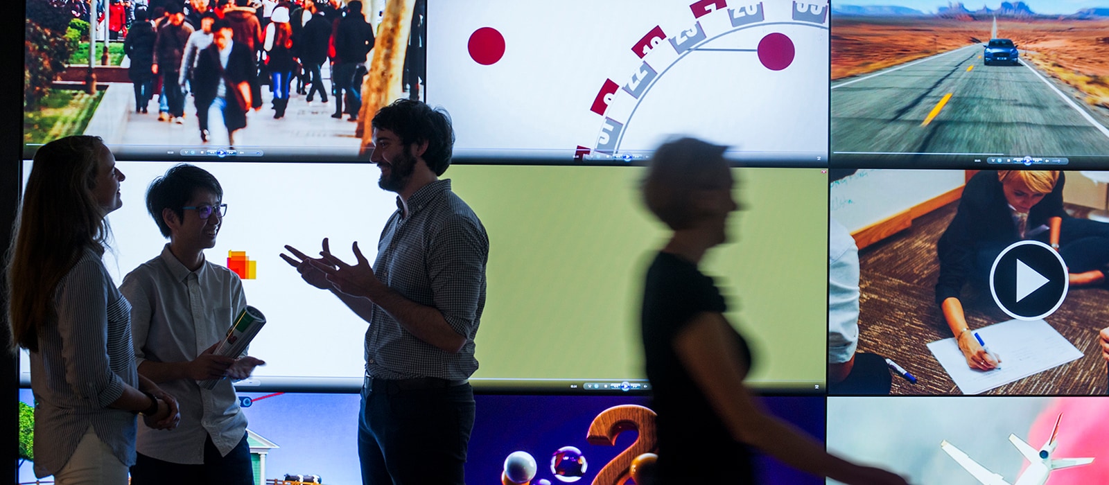 People standing infront of a interactive board