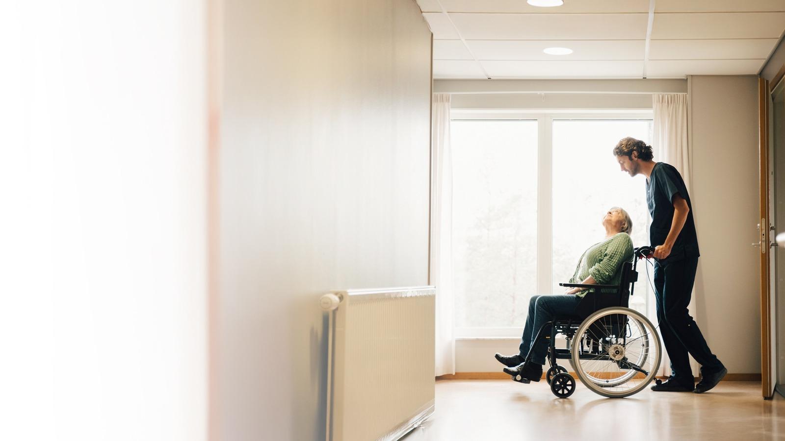 health care worker assisting an eldery women