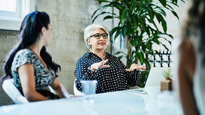 people talking around table in office