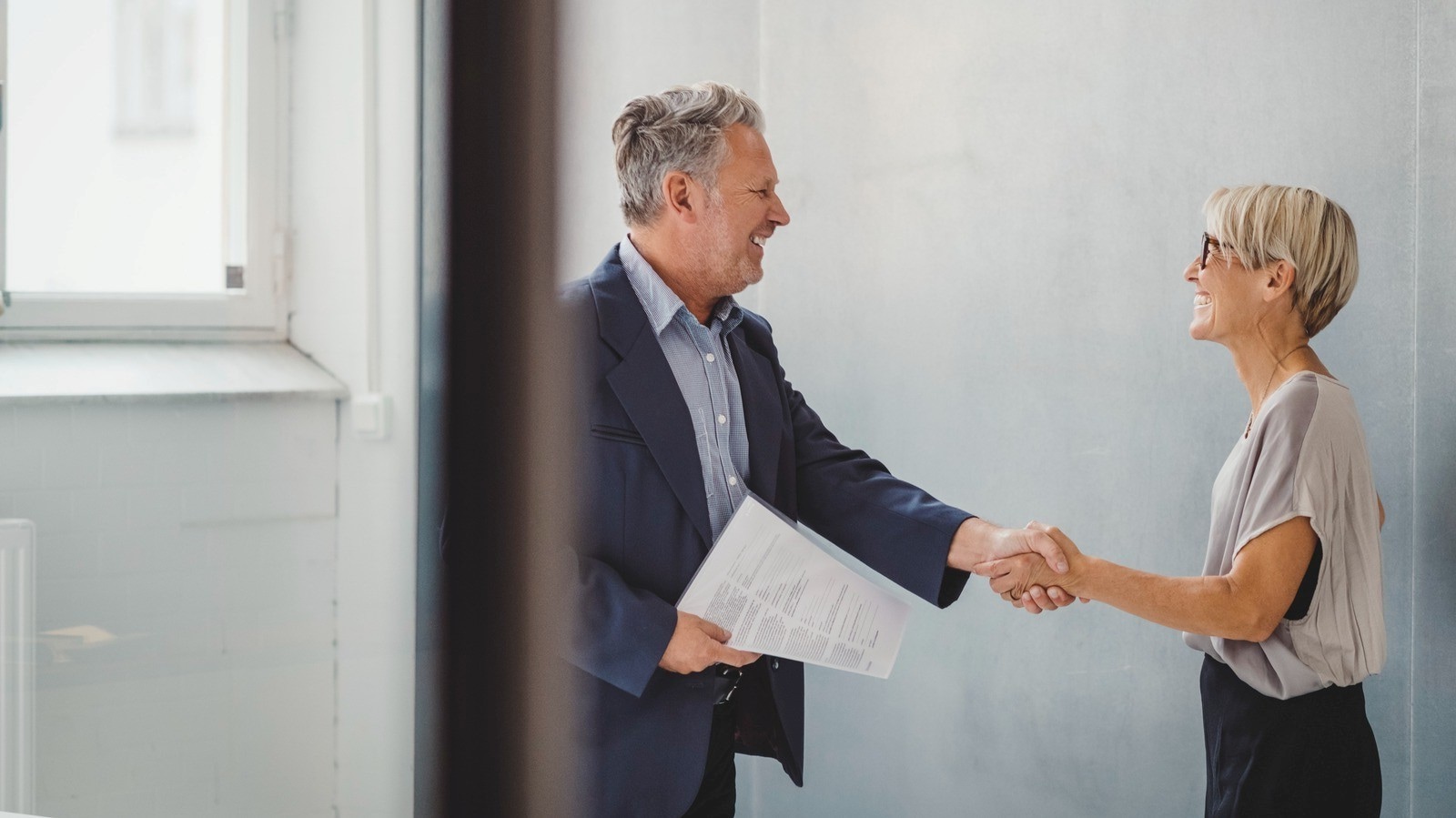 man and woman shaking hands