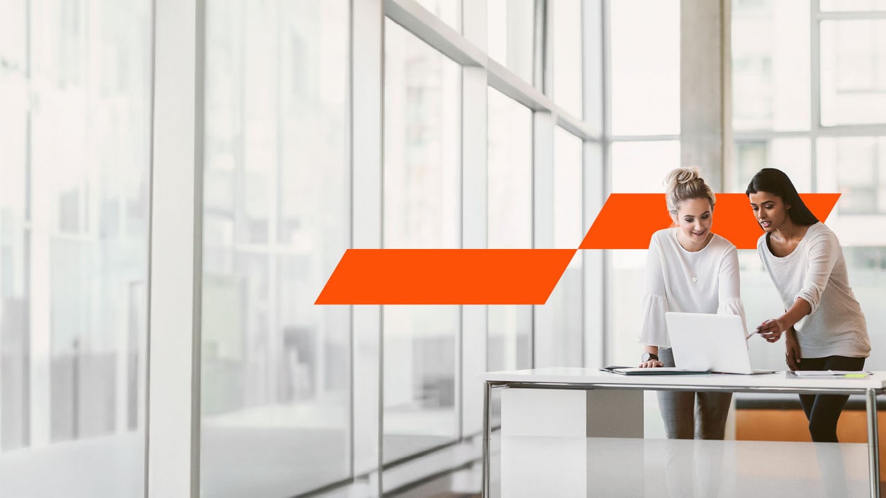 Two women looking at a work laptop