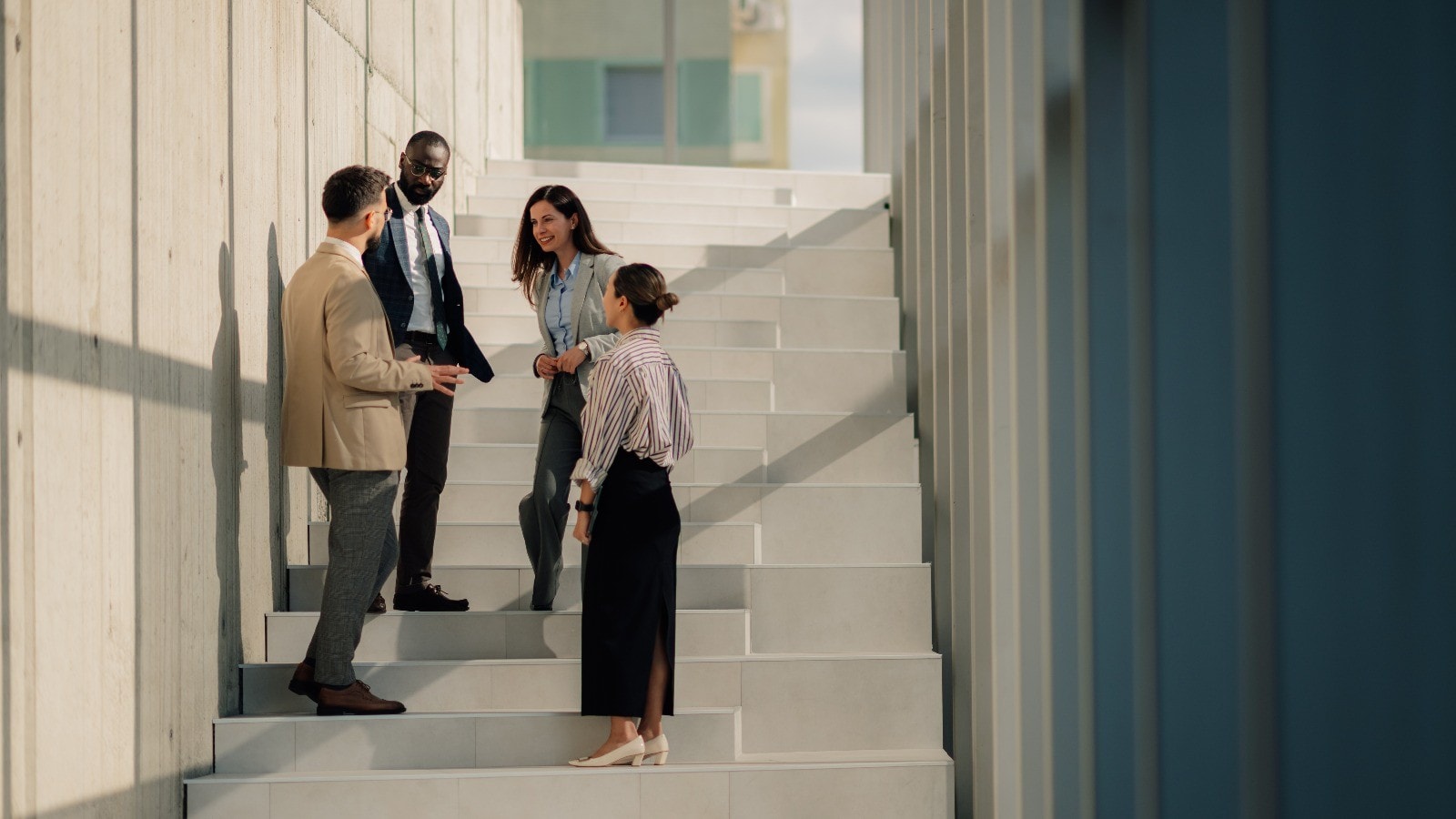 Business people talking on stairs of modern office building