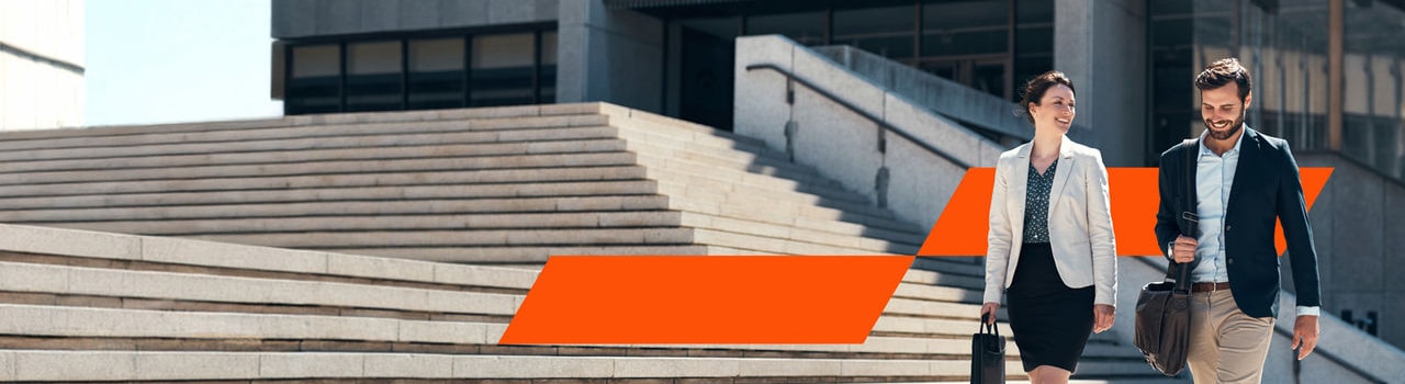 Business professionals walking near stairs outside an office building