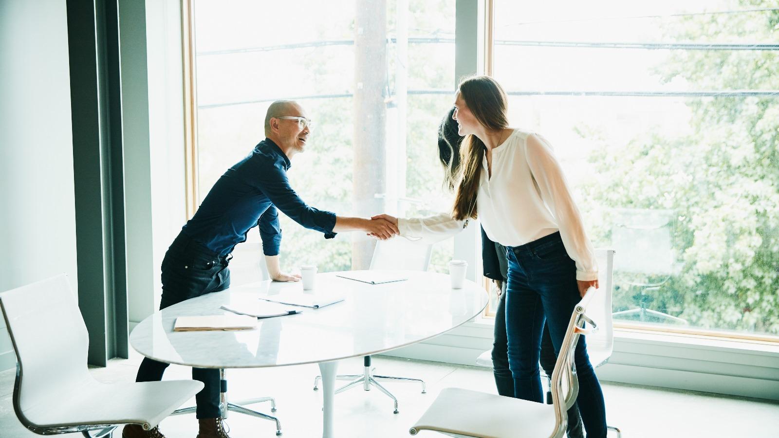 Businessman and woman shaking hands