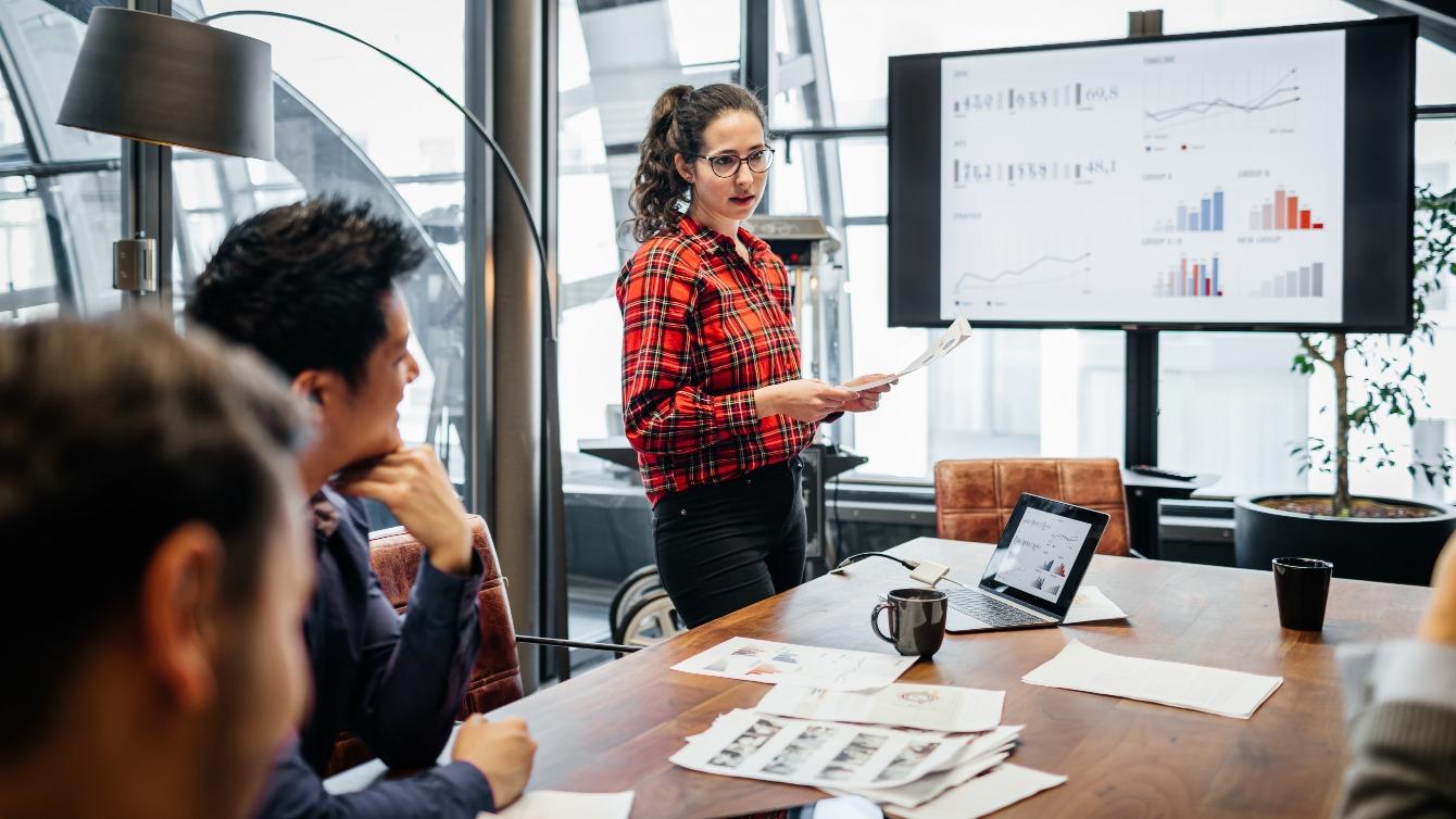 Woman at work presenting data at a meeting