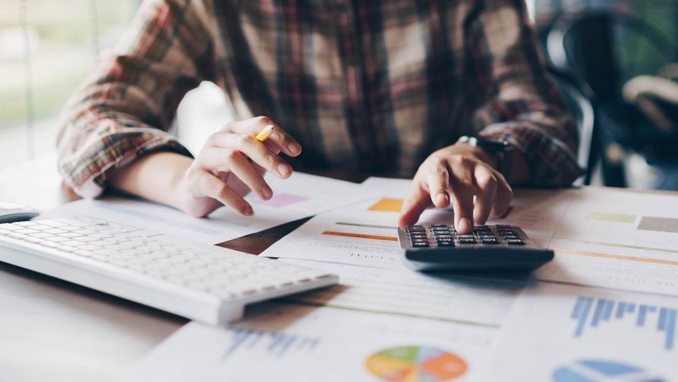 Person working at desk calculating values