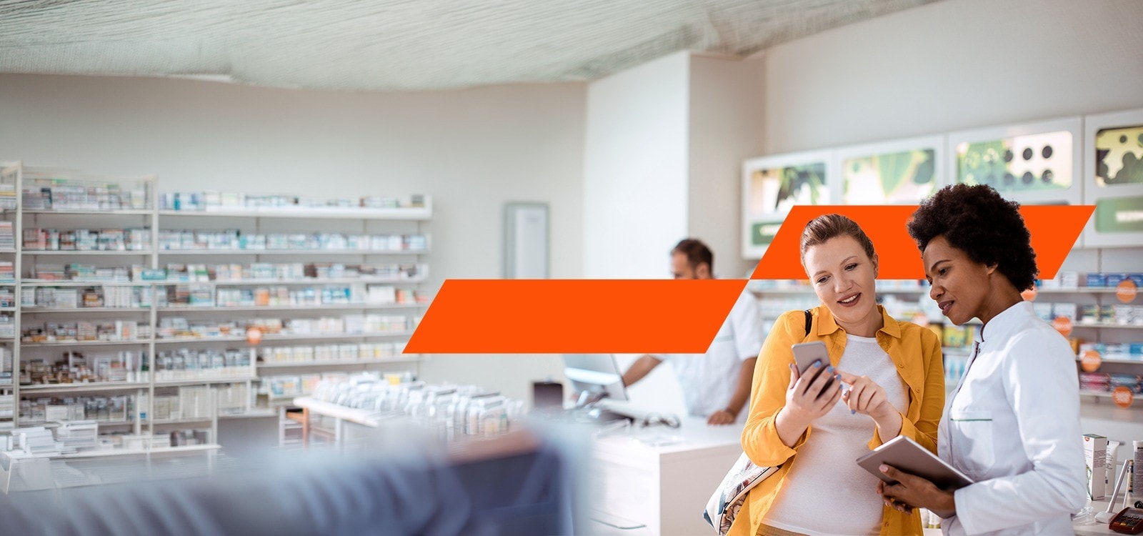 two ladies looking at a phone in a drug store