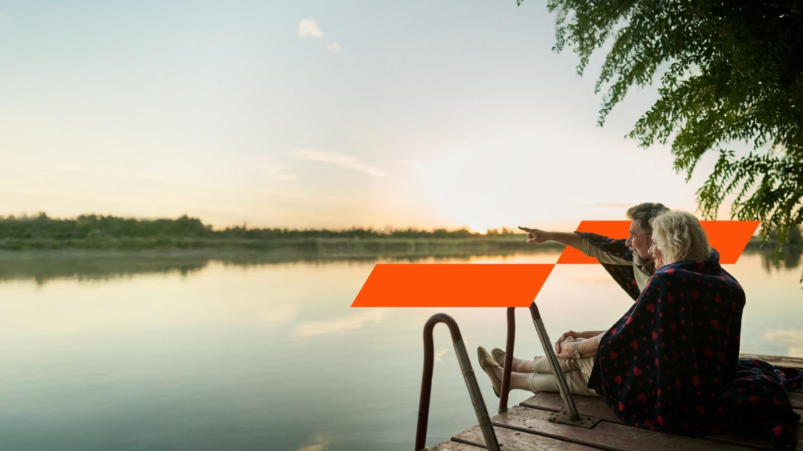 Two retirees looking across water horizon