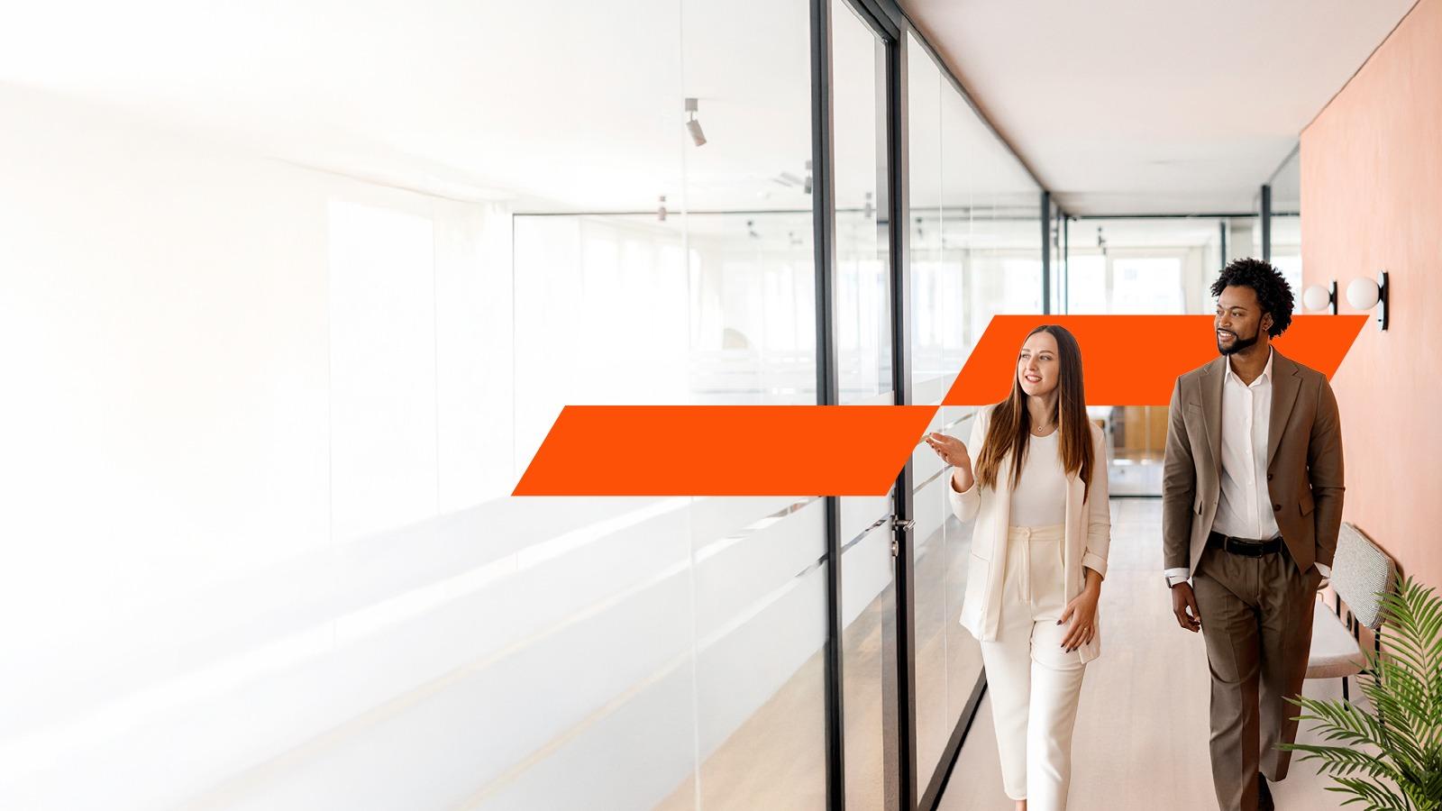 two people walking down a hall having a discussion